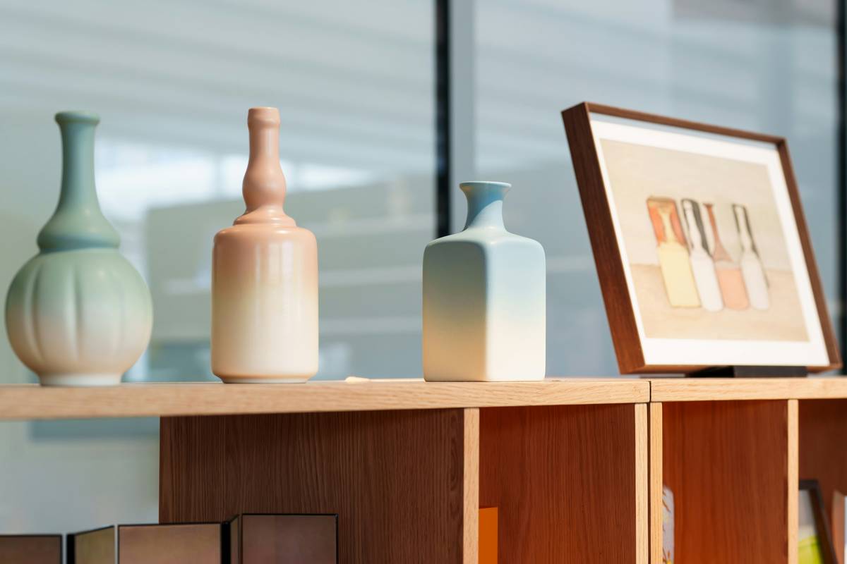 Close-up of framed still life art prints in mixed frames on a gallery wall